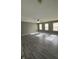Open floor plan living room with natural light from the large windows and a ceiling fan at 1881 Harvest Meadow Dr, Greenwood, IN 46143