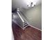 Stylish staircase with hardwood floors, modern lighting, and neutral wall paint, and a white handrail at 1881 Harvest Meadow Dr, Greenwood, IN 46143