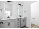 Bathroom featuring double sinks, grey vanity with black hardware, and modern fixtures at 2149 N College Ave, Indianapolis, IN 46202