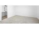 Spacious bedroom featuring plush carpeting and white walls with an ensuite bathroom at 2149 N College Ave, Indianapolis, IN 46202