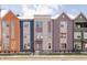 New construction home with colorful exterior, tidy landscaping, and a black metal fence at 2149 N College Ave, Indianapolis, IN 46202