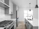 Kitchen with stainless steel gas range and grey cabinets at 2149 N College Ave, Indianapolis, IN 46202