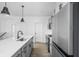 Kitchen featuring a stainless steel fridge, grey cabinets, and matte black fixtures at 2149 N College Ave, Indianapolis, IN 46202