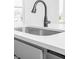 Close up of a Kitchen sink with grey cabinets and white countertops at 2149 N College Ave, Indianapolis, IN 46202