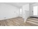 Bright living room featuring hardwood floors, white walls, and a staircase at 2149 N College Ave, Indianapolis, IN 46202