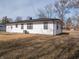 Back exterior of the house featuring white siding and dark framed windows and door at 2219 W 59Th St, Indianapolis, IN 46228