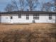 Back exterior of the house features a white siding, dark windows and door at 2219 W 59Th St, Indianapolis, IN 46228