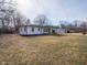 Spacious backyard showcasing the home's pristine exterior, and a detached garage with ample space at 2219 W 59Th St, Indianapolis, IN 46228