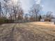 This backyard features trees, a storage building and a wood fence at 2219 W 59Th St, Indianapolis, IN 46228