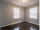 This cozy bedroom provides natural light with its two windows and features beautiful hardwood floors at 2219 W 59Th St, Indianapolis, IN 46228