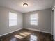Bedroom with hardwood flooring, two windows and neutral walls at 2219 W 59Th St, Indianapolis, IN 46228