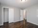 This bedroom features hardwood floors, neutral walls, and a closet for ample storage space at 2219 W 59Th St, Indianapolis, IN 46228