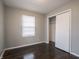 This bright bedroom features hardwood floors, a closet, and a large window, providing ample storage and natural light at 2219 W 59Th St, Indianapolis, IN 46228
