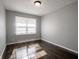 Bedroom with hardwood flooring, neutral walls and bright window at 2219 W 59Th St, Indianapolis, IN 46228