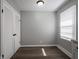 The dining room features a closet, window and gray walls with white trim and baseboards at 2219 W 59Th St, Indianapolis, IN 46228