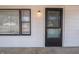 The front exterior features a window and glass door with white siding and a concrete porch at 2219 W 59Th St, Indianapolis, IN 46228