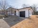 Well-maintained home featuring a covered porch, an attached garage, and a driveway at 2219 W 59Th St, Indianapolis, IN 46228