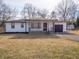 Charming home with a covered front porch, attached garage and well-maintained landscaping at 2219 W 59Th St, Indianapolis, IN 46228