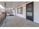 Close up view of the front porch with black railings and access to the front entry of the home at 2219 W 59Th St, Indianapolis, IN 46228