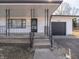 Covered front porch featuring black decorative railings and access to the home's front door at 2219 W 59Th St, Indianapolis, IN 46228