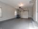 This spacious garage features a garage door, painted floors, and space for storage at 2219 W 59Th St, Indianapolis, IN 46228