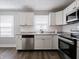 Bright kitchen with stainless steel appliances, white cabinets and a window over the sink at 2219 W 59Th St, Indianapolis, IN 46228