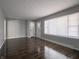 A spacious living room features hardwood floors, light gray walls and two entryways at 2219 W 59Th St, Indianapolis, IN 46228