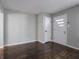A spacious living room features hardwood floors, light gray walls and front entry door at 2219 W 59Th St, Indianapolis, IN 46228