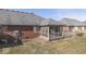 Brick home with a screened-in porch and manicured lawn, set in a residential neighborhood at 223 Andrews Boulevard East Dr, Plainfield, IN 46168