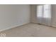 Bright bedroom with neutral carpet, white walls, and natural light streaming through the window at 223 Andrews Boulevard East Dr, Plainfield, IN 46168