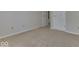 Bedroom featuring neutral carpet and white walls, with a glimpse of an open doorway at 223 Andrews Boulevard East Dr, Plainfield, IN 46168