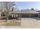 Charming brick home featuring a three-car garage and a well-manicured front yard and nice curb appeal at 223 Andrews Boulevard East Dr, Plainfield, IN 46168