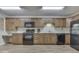 Functional kitchen featuring wood cabinets, sleek black appliances, and plenty of counter space for cooking at 223 Andrews Boulevard East Dr, Plainfield, IN 46168