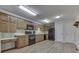 Well-equipped kitchen with wood cabinetry, black appliances, and ample counter space for meal preparation at 223 Andrews Boulevard East Dr, Plainfield, IN 46168