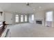Spacious living room featuring a fireplace, neutral carpet, lots of windows, and ample natural light at 223 Andrews Boulevard East Dr, Plainfield, IN 46168