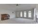 Spacious living room with vaulted ceiling, featuring a fireplace, neutral carpet, and lots of windows at 223 Andrews Boulevard East Dr, Plainfield, IN 46168