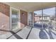 Screened-in porch with access to backyard, featuring brick accents and door with glass pane at 223 Andrews Boulevard East Dr, Plainfield, IN 46168