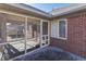 Enclosed sunroom with access to backyard, showcasing brick exterior and access to the yard at 223 Andrews Boulevard East Dr, Plainfield, IN 46168