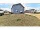 Large backyard is surrounded by a black metal fence with a set of patio furniture at 28 Lively Pl, Cicero, IN 46034