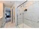 Bright bathroom featuring glass enclosed shower with white marble tiling and neutral colored walls and flooring at 28 Lively Pl, Cicero, IN 46034