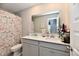 Bathroom with a double sink vanity, granite countertop, modern fixtures, and a stylish floral shower curtain at 28 Lively Pl, Cicero, IN 46034