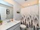 Well-lit bathroom featuring a modern vanity, decorative mirror, and a shower with a stylish curtain design at 28 Lively Pl, Cicero, IN 46034
