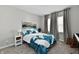 Serene bedroom with neutral tones, a cozy quilt on the bed, and soft natural light filtering through the windows at 28 Lively Pl, Cicero, IN 46034