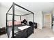 Bedroom featuring four poster bed frame, neutral colored walls and carpet, and dark finish work desk at 28 Lively Pl, Cicero, IN 46034