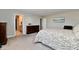 Bedroom featuring carpet, a wooden bed frame with two dressers, and an attached bathroom at 28 Lively Pl, Cicero, IN 46034