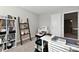 Well-lit room showing a wooden leaning ladder bookshelf and white storage table with sewing machine, and rolling storage cart at 28 Lively Pl, Cicero, IN 46034