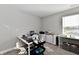 Well-lit room featuring a white desk, laptop, storage drawers, and a rolling cart for organizing supplies at 28 Lively Pl, Cicero, IN 46034