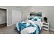 Cozy bedroom with a comfortable bed featuring a stylish blue and white quilt, complemented by neutral wall colors at 28 Lively Pl, Cicero, IN 46034