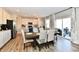 Open floor plan featuring the kitchen with an island and stainless appliances, as well as the dining area and patio at 28 Lively Pl, Cicero, IN 46034
