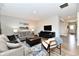 Bright and airy living room with comfortable seating, a dark wood coffee table, and a large TV for entertainment at 28 Lively Pl, Cicero, IN 46034